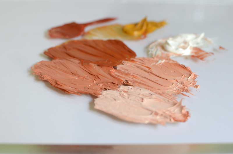 Peachy flesh tone oil paint on palette